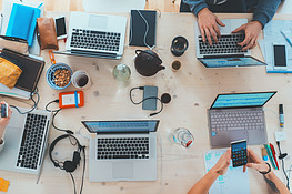 People at a around table with computers